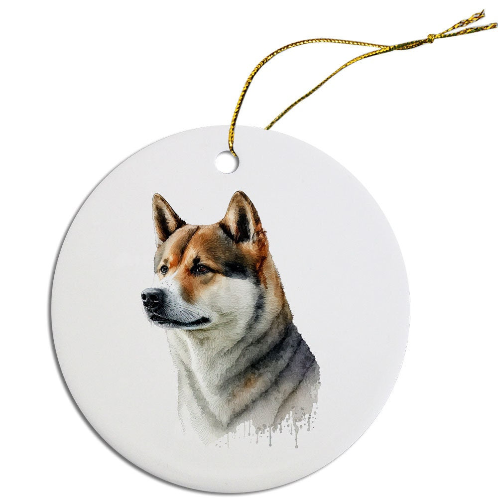 Ceramic round Christmas ornament featuring an Akita dog design with a golden string for hanging.