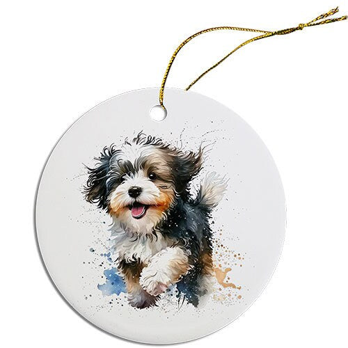 Ceramic round Christmas ornament featuring a Havanese dog design with a golden string for hanging.