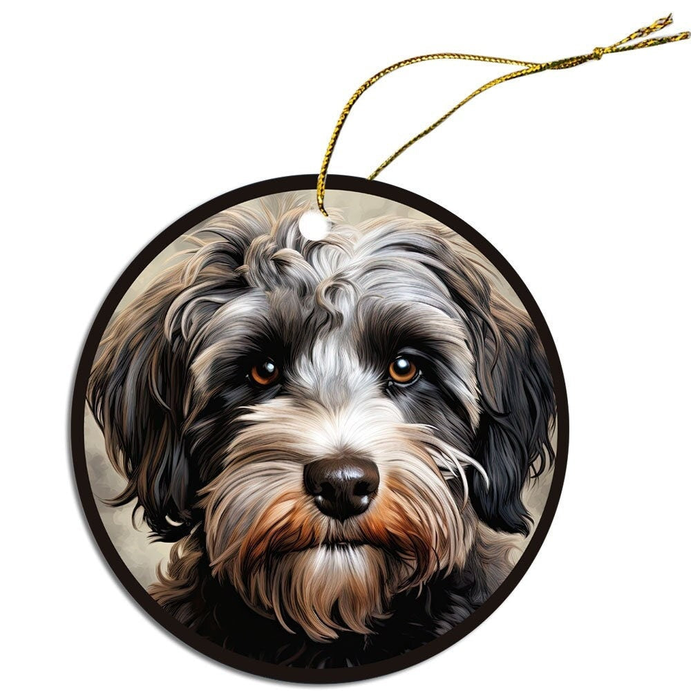 Ceramic round Christmas ornament featuring a Schnoodle design with a golden string for hanging.
