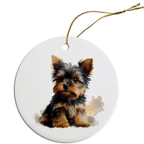 A round ceramic Christmas ornament featuring a cute Yorkie design, with a golden string for hanging.