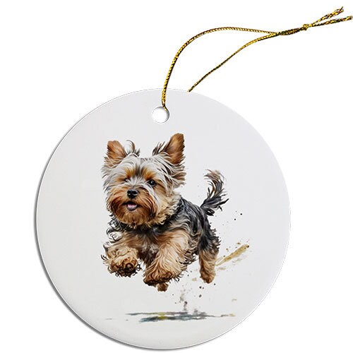 A round ceramic Christmas ornament featuring a cute Yorkie design, with a golden string for hanging.