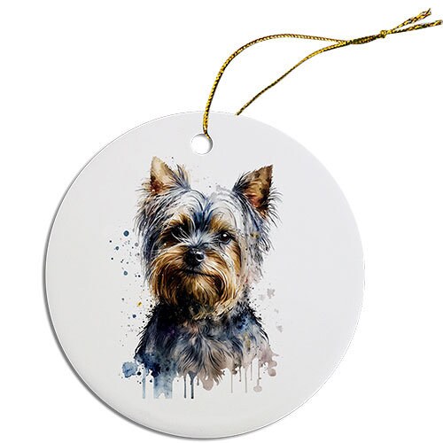 A round ceramic Christmas ornament featuring a cute Yorkie design, with a golden string for hanging.
