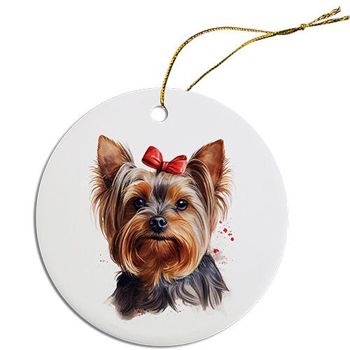 A round ceramic Christmas ornament featuring a cute Yorkie design, with a golden string for hanging.