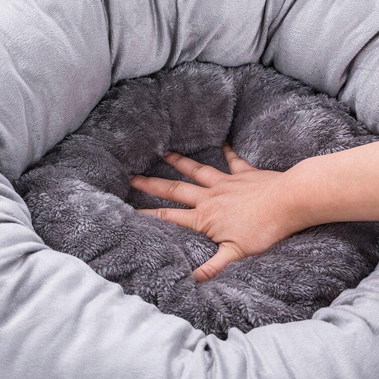 Cute round pet bed for dogs and cats, featuring a soft pillow and warm fabric, perfect for winter use.