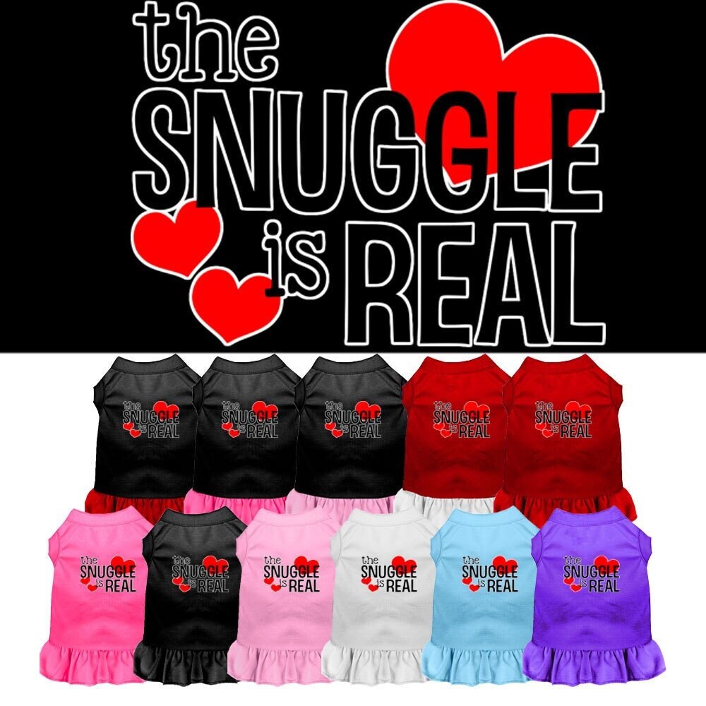 A cute dog wearing a soft, stylish dress with the phrase 'The Snuggle Is Real' printed on it, showcasing comfort and fashion.