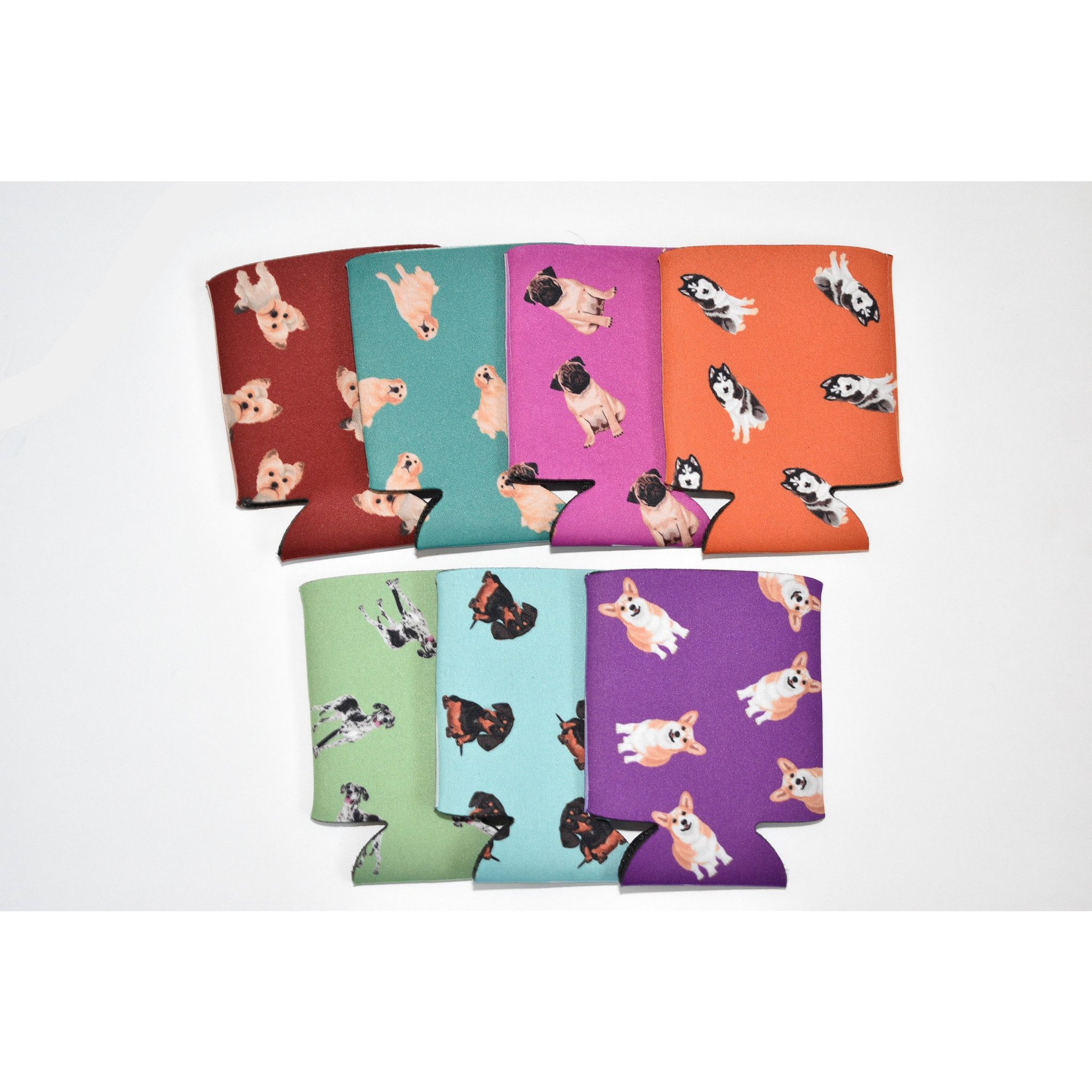 A colorful Dog Inspired Can Holder made of poly foam, designed to hold 12-16 oz. cans, featuring a playful dog-themed print.