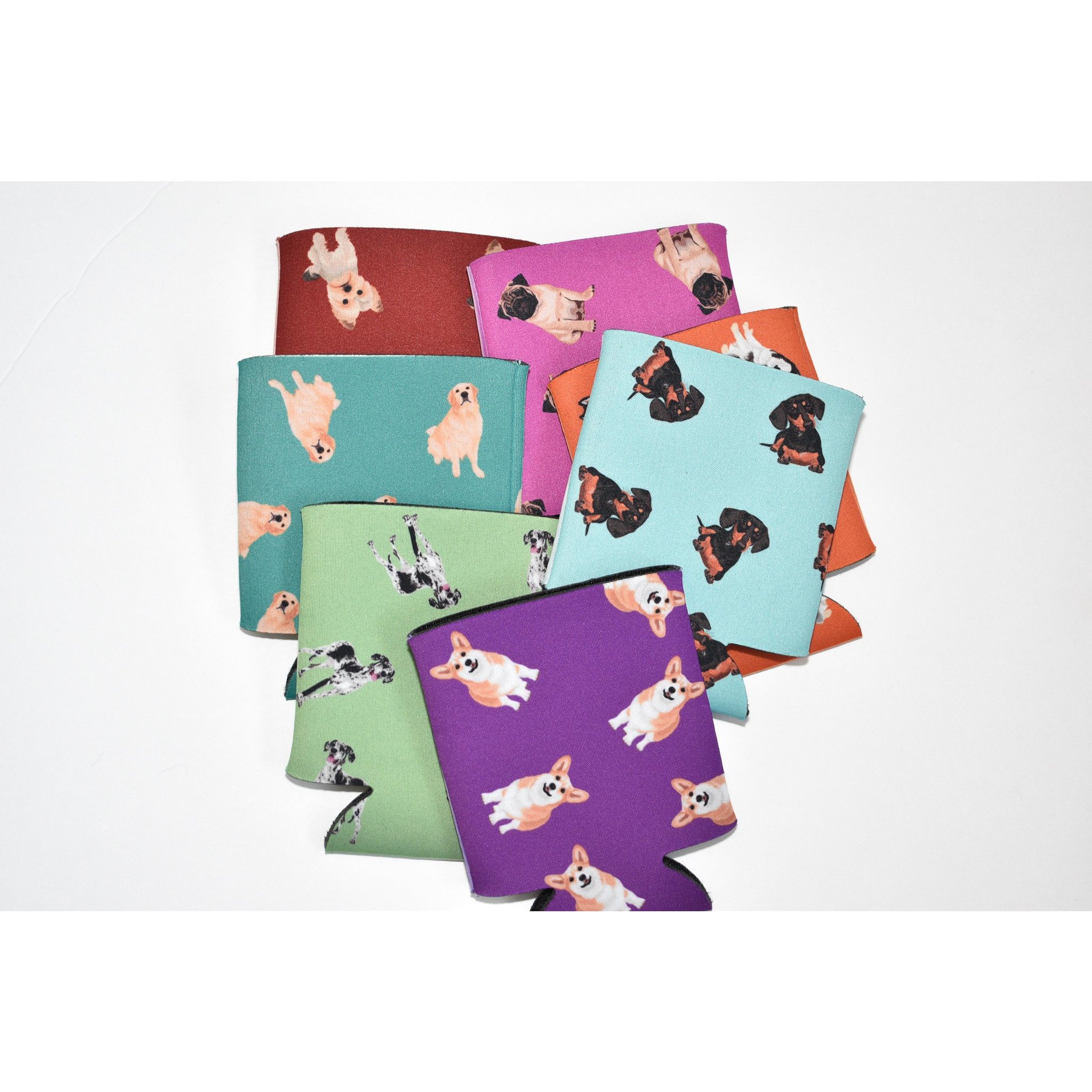 A colorful Dog Inspired Can Holder made of poly foam, designed to hold 12-16 oz. cans, featuring a playful dog-themed print.