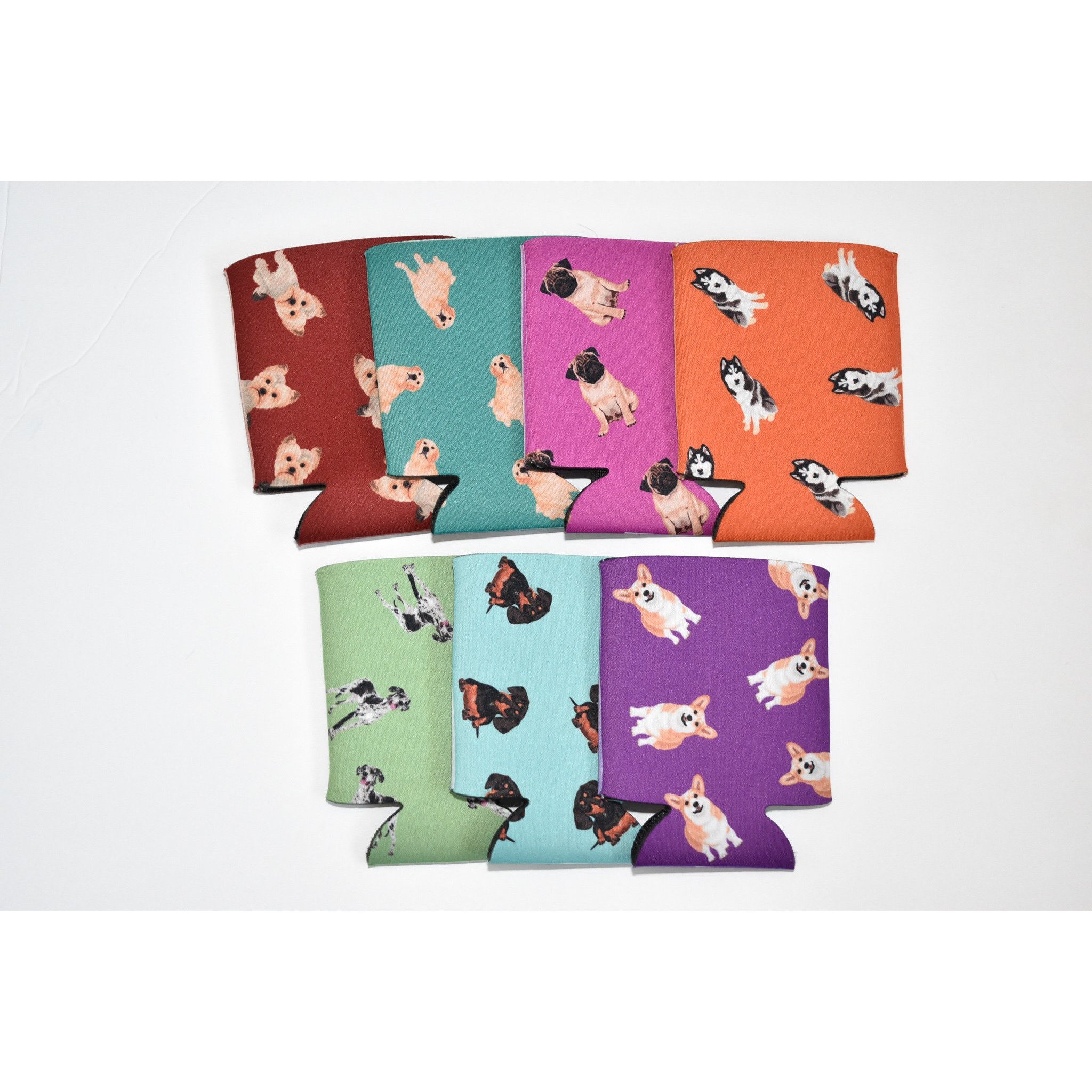 A colorful Dog Inspired Can Holder made of poly foam, designed to hold 12-16 oz. cans, featuring a playful dog-themed print.