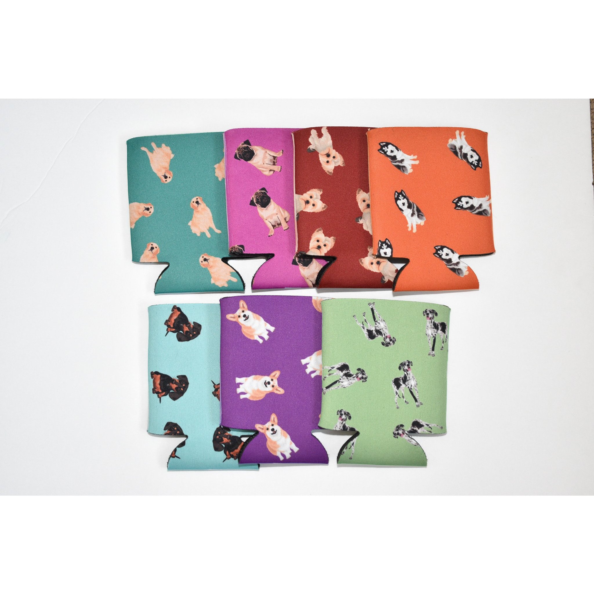 A colorful Dog Inspired Can Holder made of poly foam, designed to hold 12-16 oz. cans, featuring a playful dog-themed print.