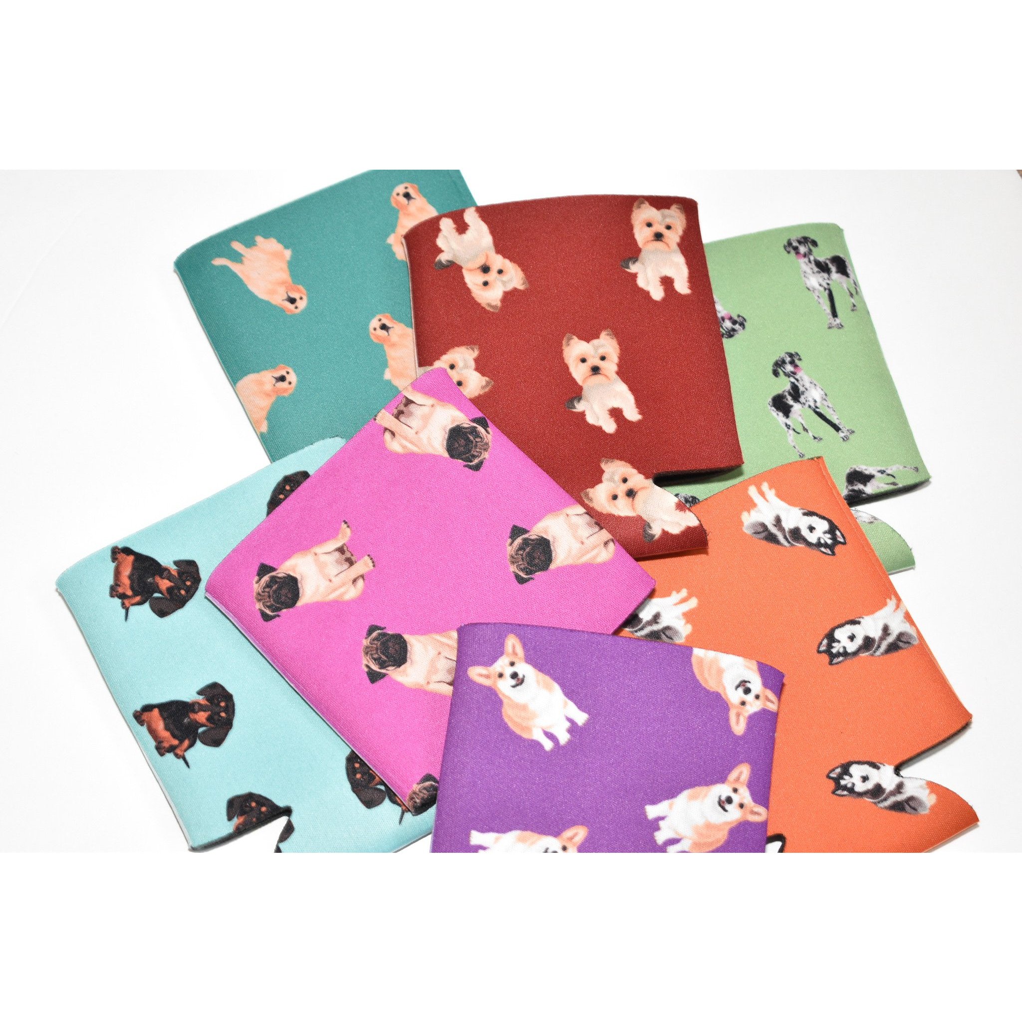 A colorful Dog Inspired Can Holder made of poly foam, designed to hold 12-16 oz. cans, featuring a playful dog-themed print.