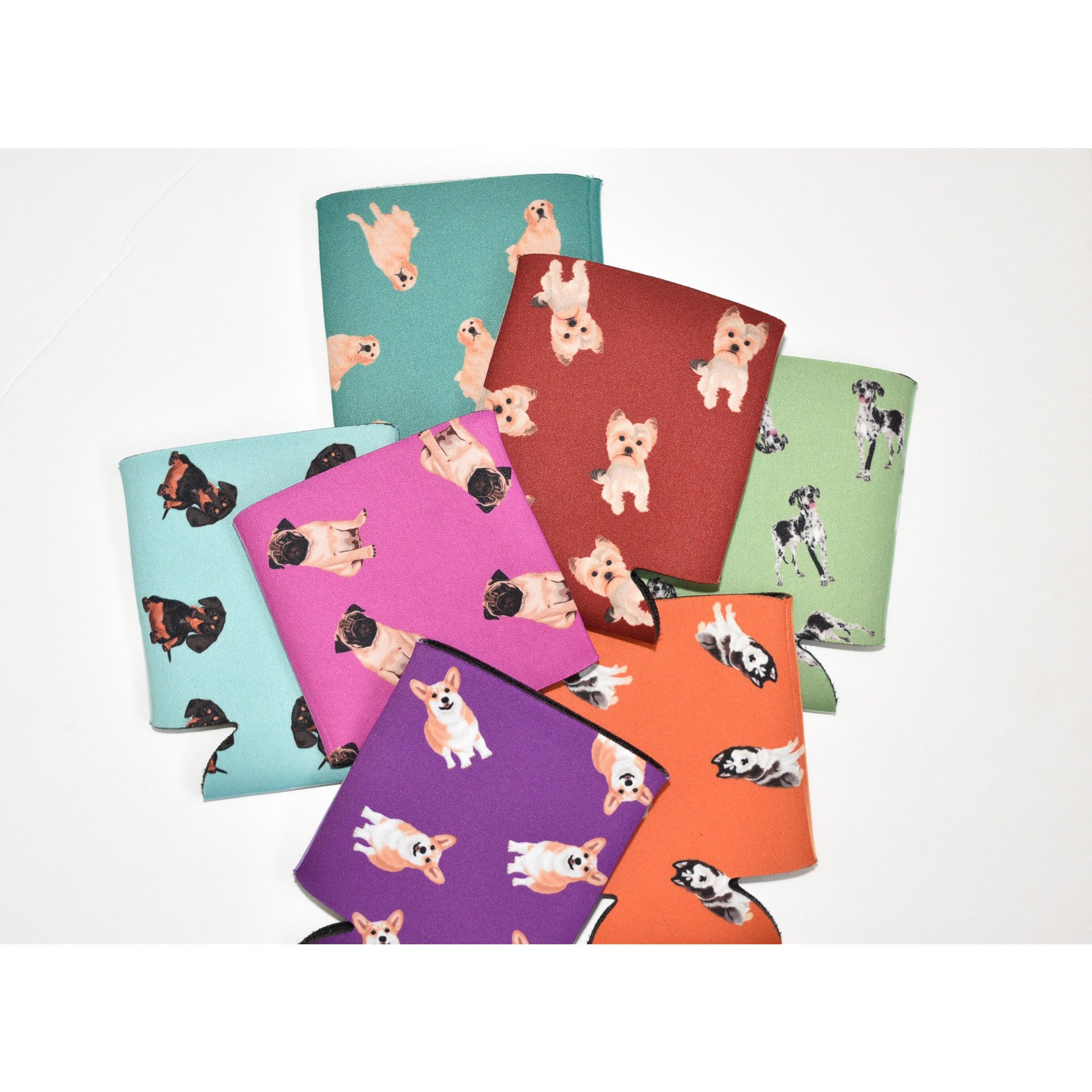 A colorful Dog Inspired Can Holder made of poly foam, designed to hold 12-16 oz. cans, featuring a playful dog-themed print.