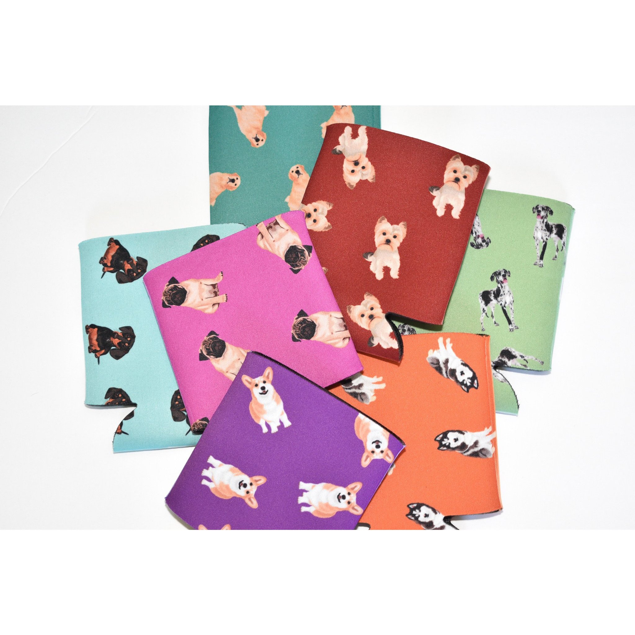 A colorful Dog Inspired Can Holder made of poly foam, designed to hold 12-16 oz. cans, featuring a playful dog-themed print.