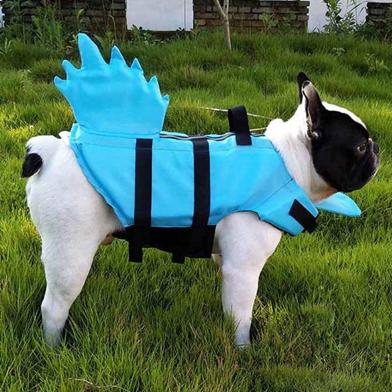 A vibrant shark-themed dog life vest designed for swimming, featuring adjustable straps and a sturdy handle for safety.