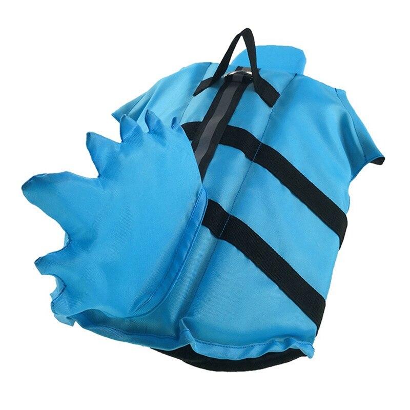 A vibrant shark-themed dog life vest designed for swimming, featuring adjustable straps and a sturdy handle for safety.