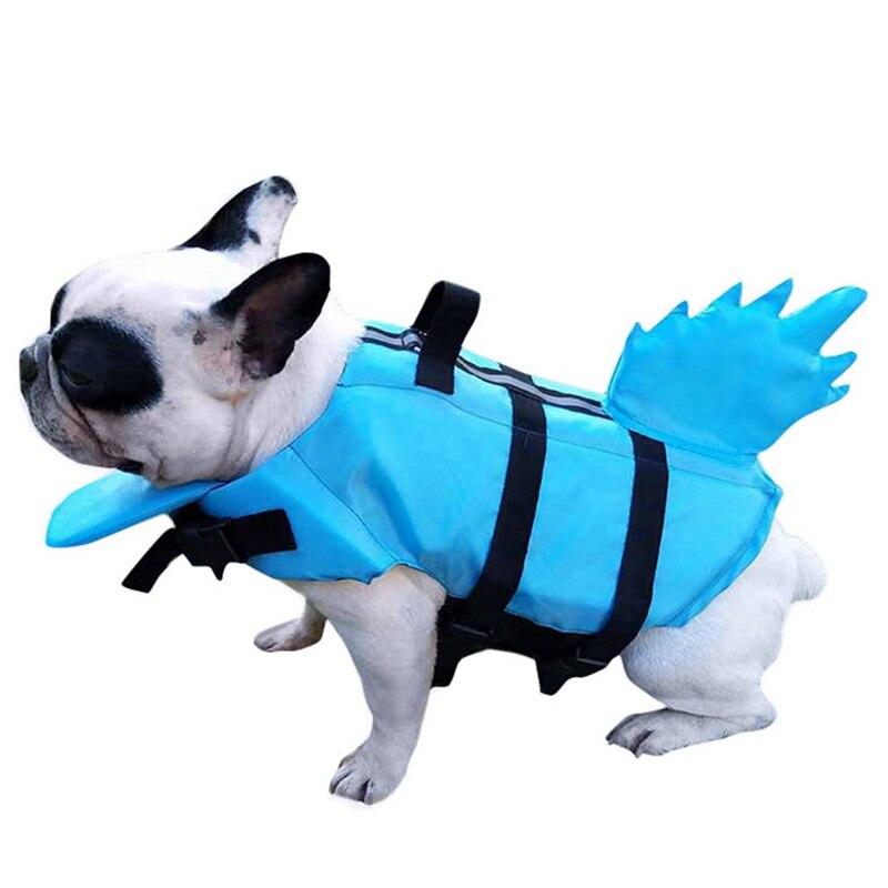 A vibrant shark-themed dog life vest designed for swimming, featuring adjustable straps and a sturdy handle for safety.
