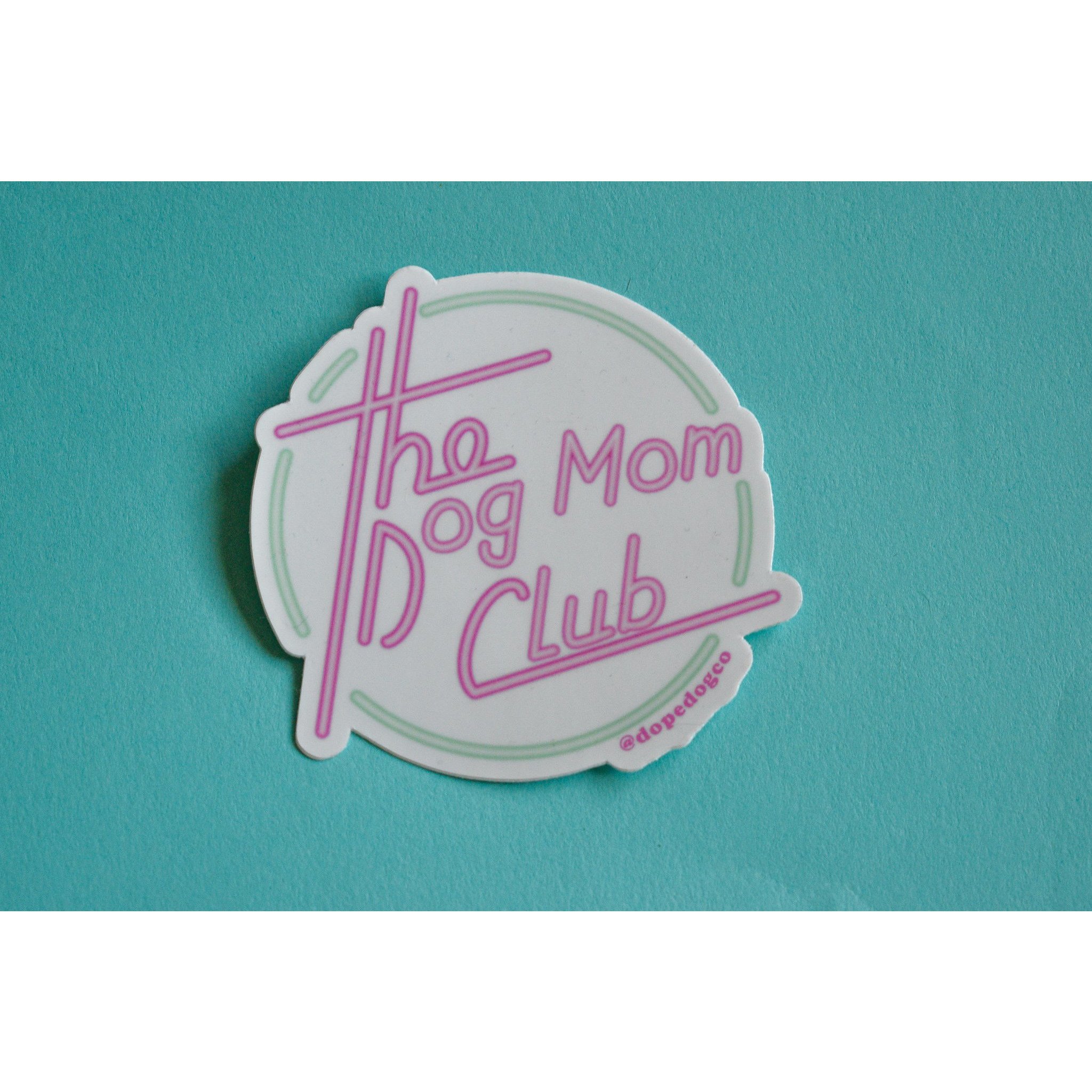 A vibrant Dog Mom Club sticker featuring the phrase 'The Dog Mom Club' on a durable background, perfect for dog lovers.
