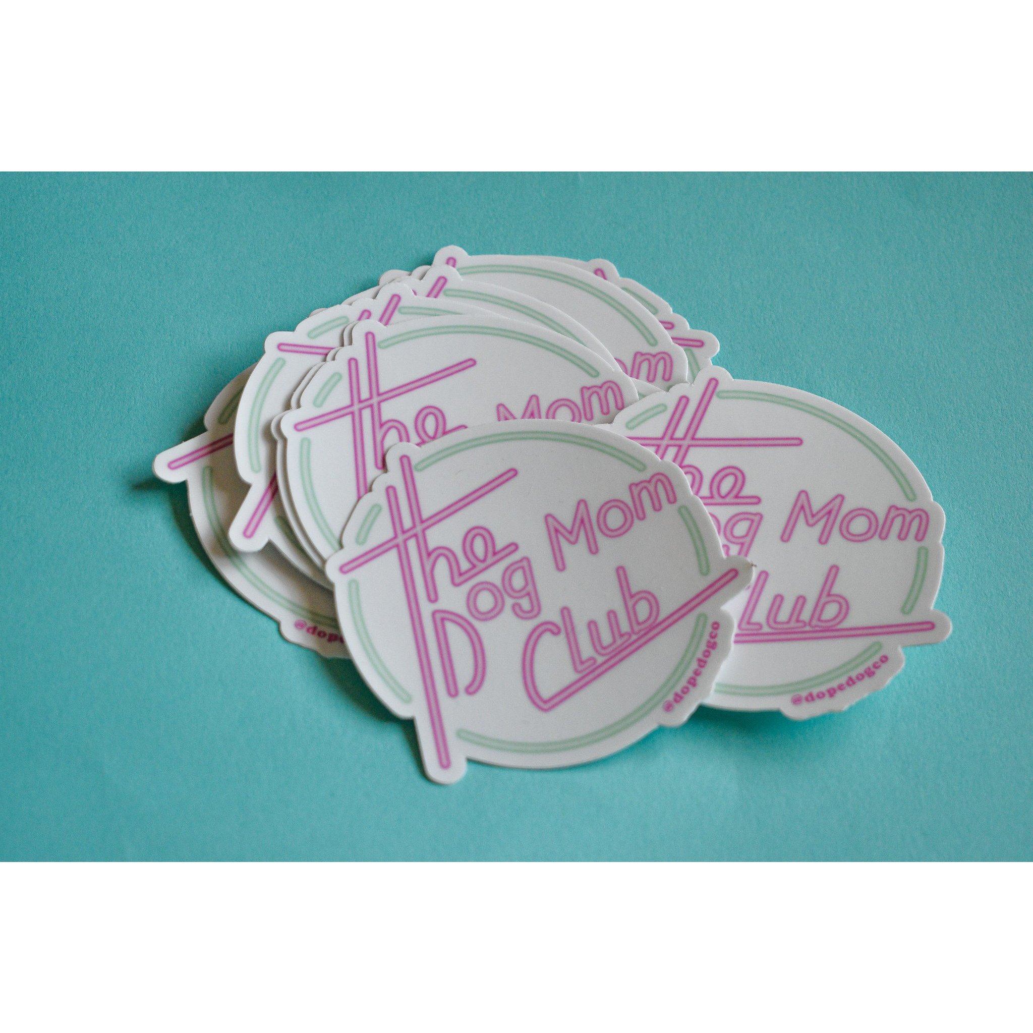 A vibrant Dog Mom Club sticker featuring the phrase 'The Dog Mom Club' on a durable background, perfect for dog lovers.