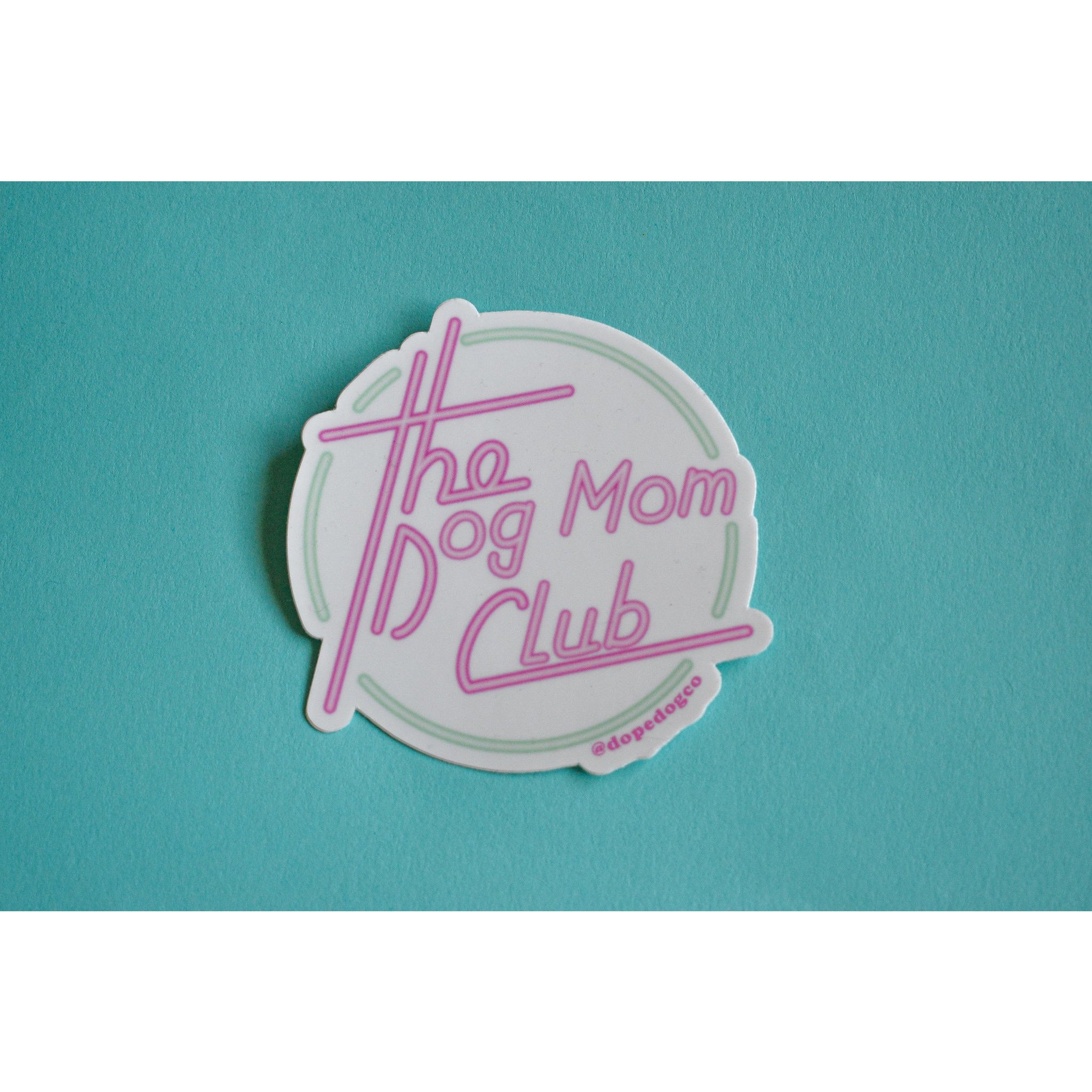 A vibrant Dog Mom Club sticker featuring the phrase 'The Dog Mom Club' on a durable background, perfect for dog lovers.