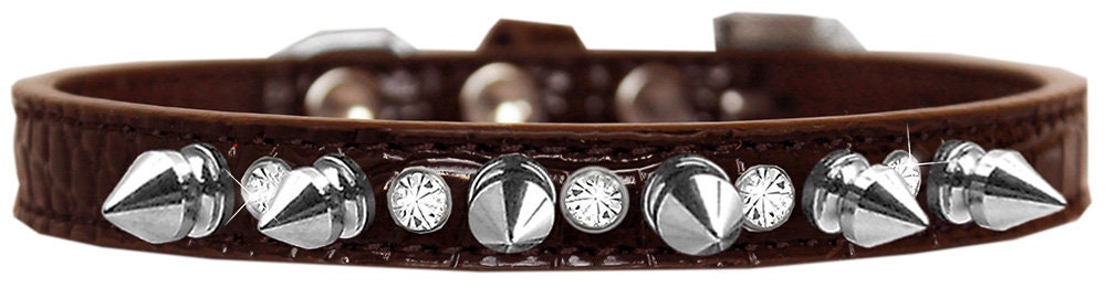 A stylish dog collar featuring silver spikes and clear jewels on a faux leather base, showcasing elegance and sophistication for pets.