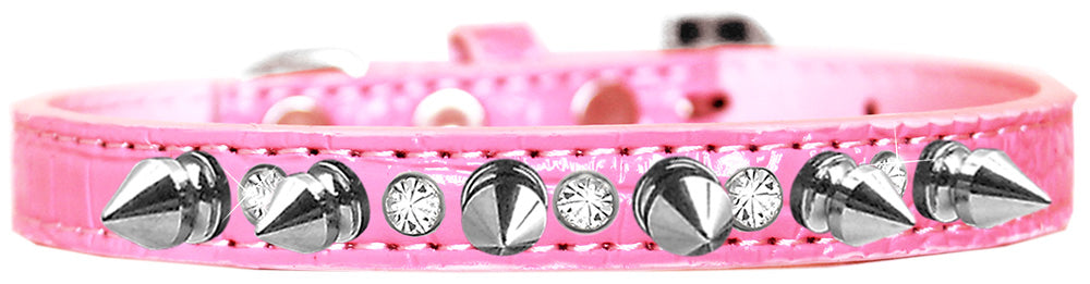 A stylish dog collar featuring silver spikes and clear jewels on a faux leather base, showcasing elegance and sophistication for pets.