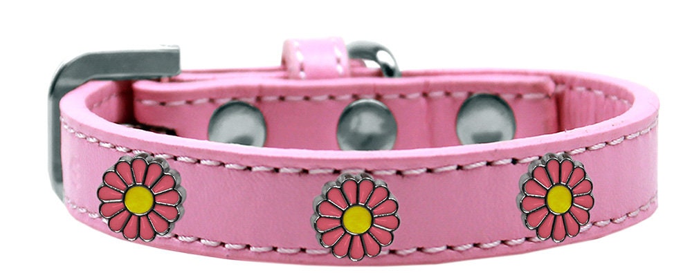 A stylish pink collar for dogs featuring daisies and metal widgets, showcasing a fashionable design.