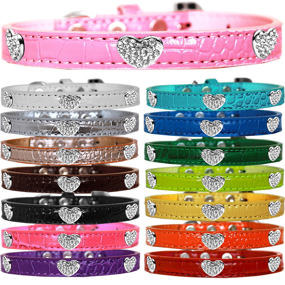 A stylish dog collar featuring crystal heart designs on a durable faux leather base, available in various colors and sizes.