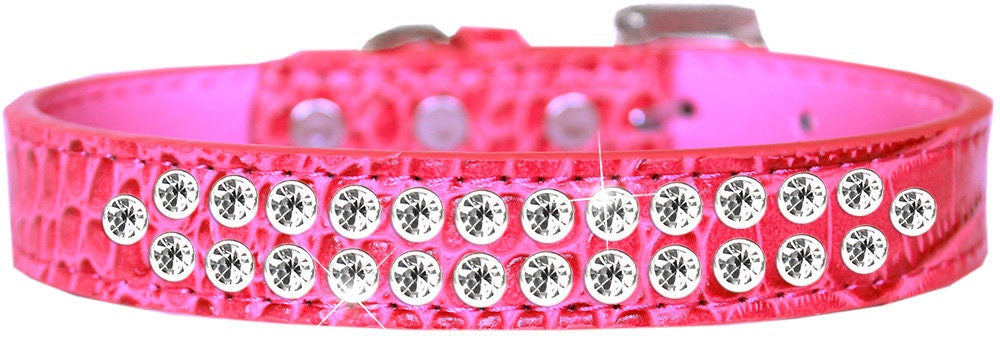 A stylish dog collar made of faux leather featuring two rows of clear crystal stones, designed for pets to add elegance to their look.