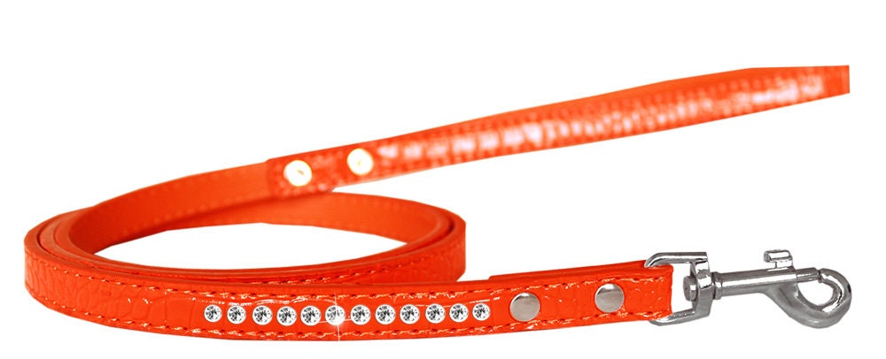 A stylish dog leash made of faux croc material with a row of clear crystals, perfect for pets.