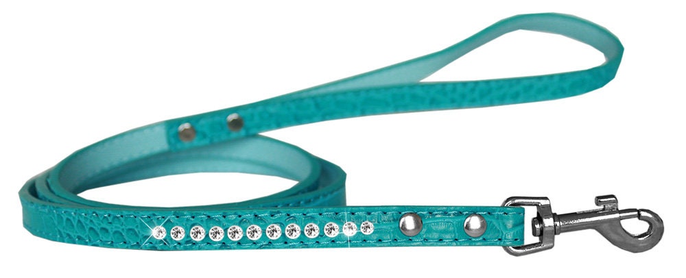 A stylish dog leash made of faux croc material with a row of clear crystals, perfect for pets.