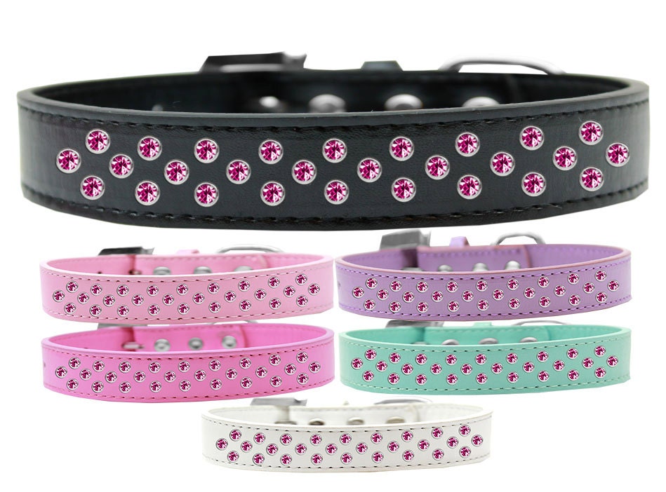 Bright pink dog collar with three rows of sparkling crystals, made from soft faux leather, perfect for stylish pets.