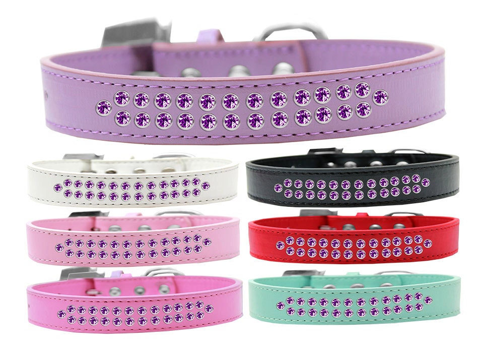 Stylish dog collar featuring two rows of purple crystals on a faux leather base, complete with a crystal buckle.