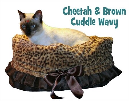 Cheetah patterned reversible pet bed, bag, and car seat for dogs and cats, featuring a cozy design with matching blanket and cushion.
