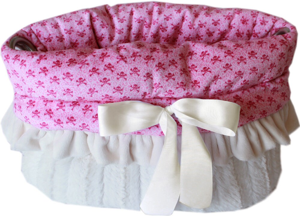 Reversible Snuggle Bugs Pet Bed in light pink and baby blue skulls, featuring a cozy design for dogs and cats, with a matching blanket and cushion.