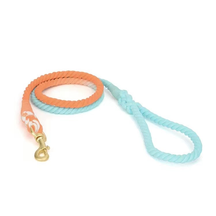 Vibrant sunset-colored dog rope leash made from hand woven cotton with solid brass hardware.