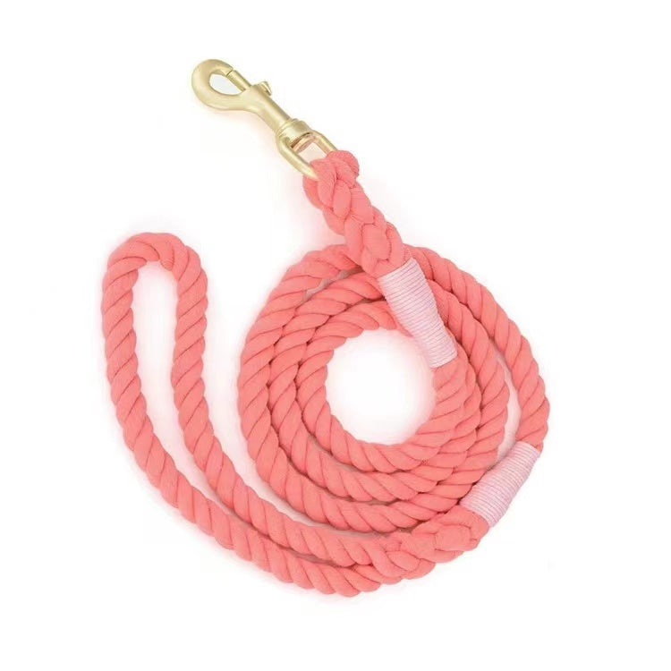 A vibrant Watermelon Red Dog Rope Leash made from hand woven cotton with solid brass hardware, perfect for outdoor adventures.