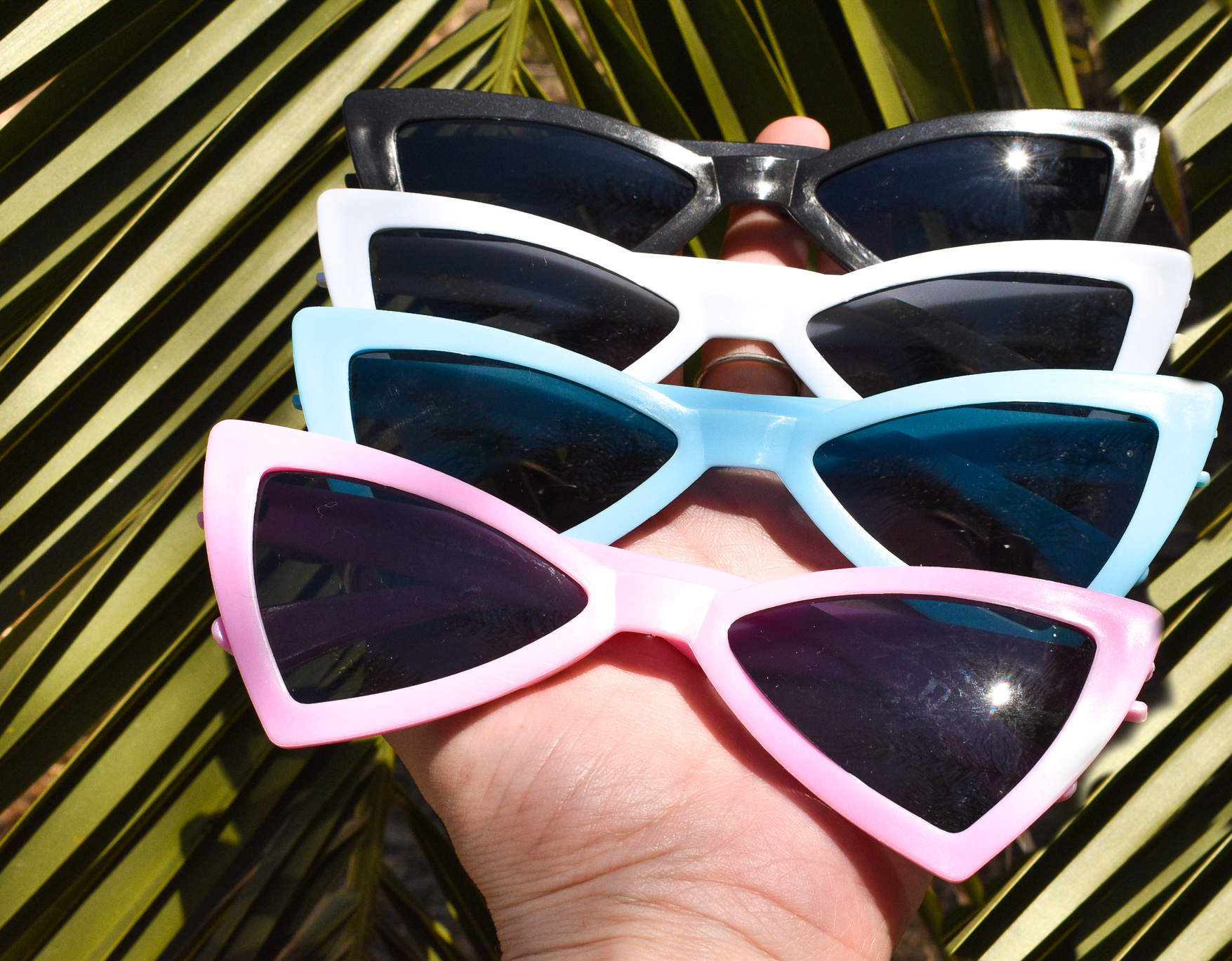 A pair of stylish retro-shaped dog sunglasses designed for pets, showcasing a fun and protective accessory for sunny days.