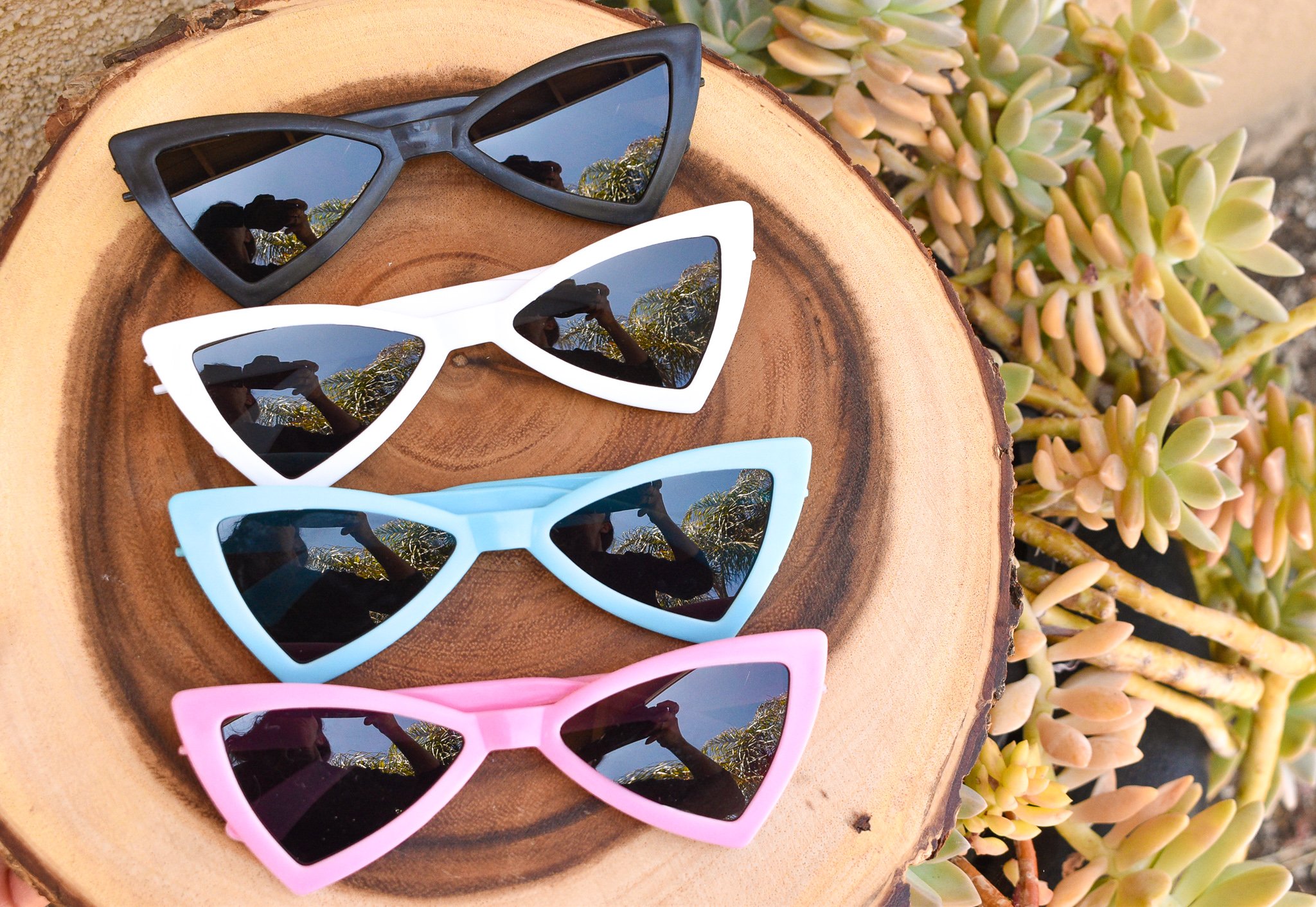 A pair of stylish retro-shaped dog sunglasses designed for pets, showcasing a fun and protective accessory for sunny days.