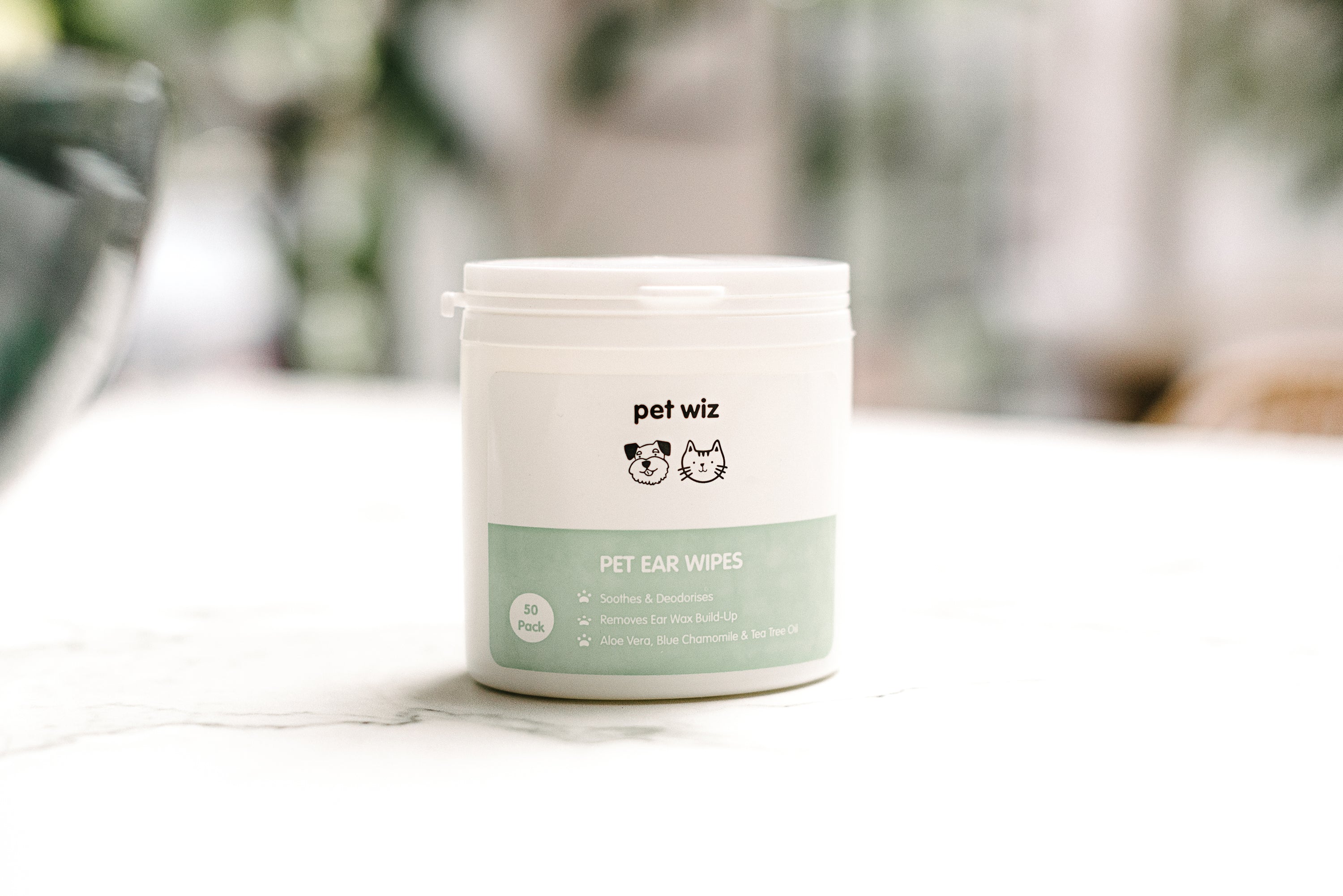 A tub of Ear Wipes for Dogs & Cats, featuring natural ingredients like Aloe Vera and tea tree oil, designed for easy ear cleaning.