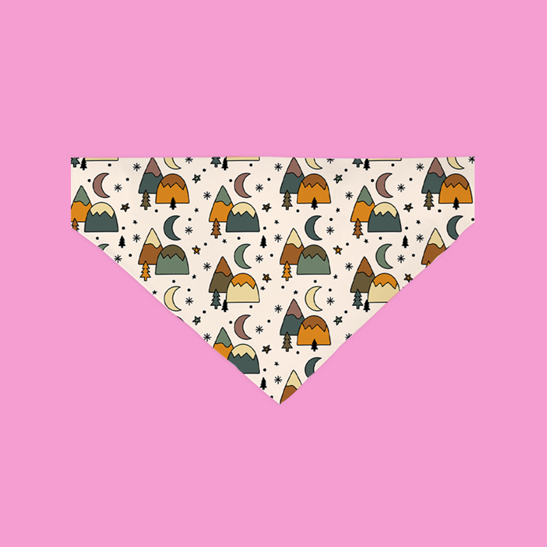 A colorful Explore More Bandana designed for dogs, featuring soft polyester fabric and a slip-on design for easy wear.