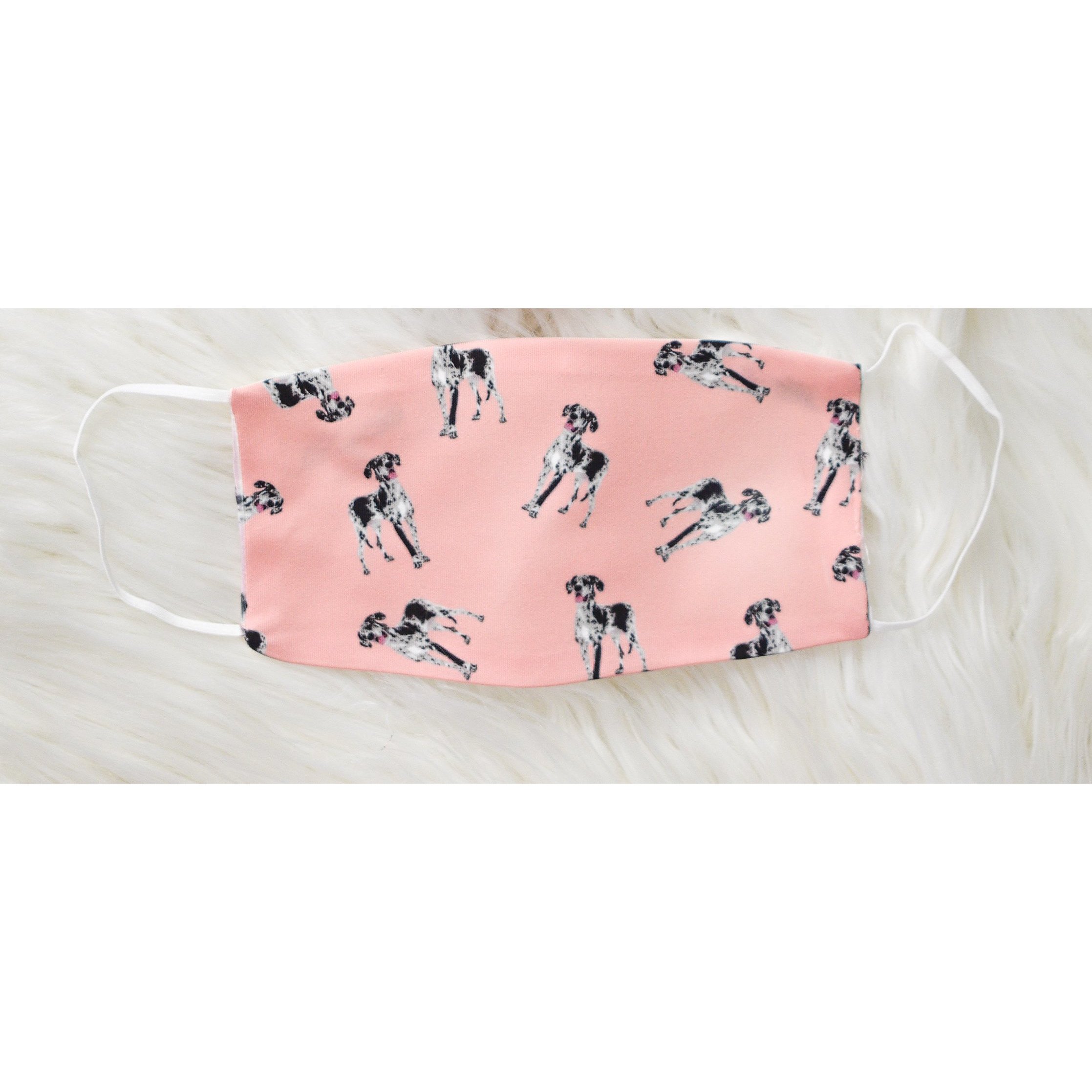 Handmade face coverings for kids, featuring soft polyester front and organic cotton interior, available in two sizes.