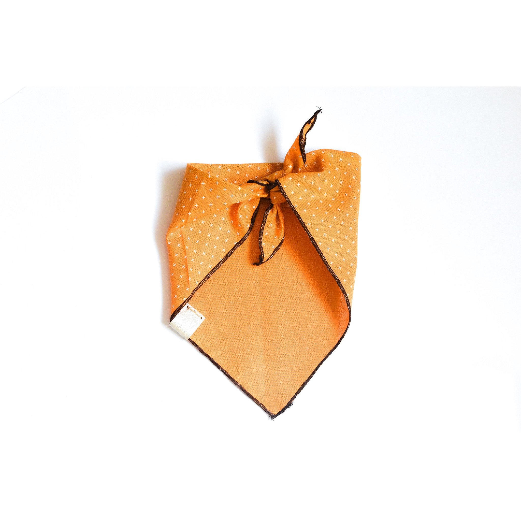 A stylish Feeling Blessed dog bandana made of lightweight cotton fabric, featuring a vegan leather tag, perfect for mini and giant dogs.