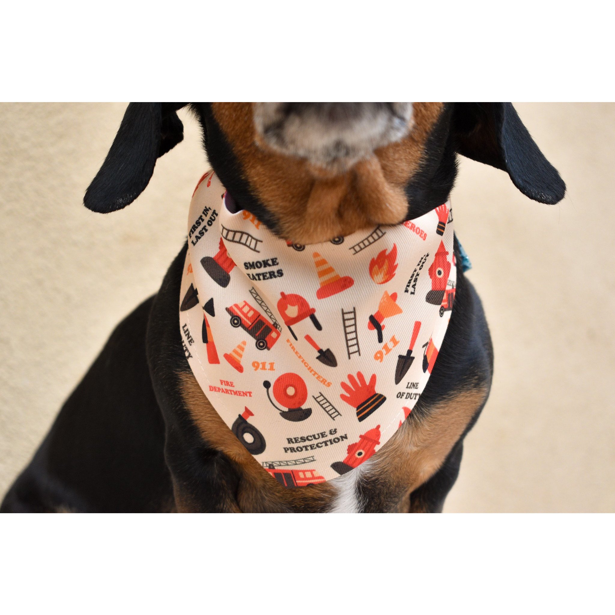 A reversible Fire Dog Bandana for dogs, showcasing a vibrant design that supports firefighters, made from durable canvas fabric.