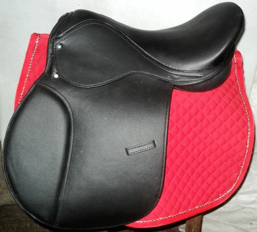 Genuine black leather jumping English riding horse saddle with tack accessories, showcasing its elegant design and quality craftsmanship.