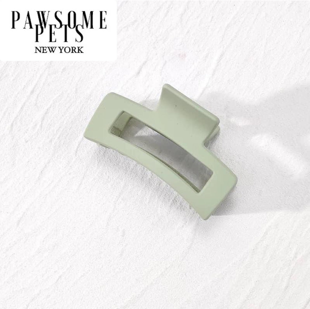 A pair of stylish green hair claws designed for thick and long hair, showcasing their elegant design and sturdy grip.