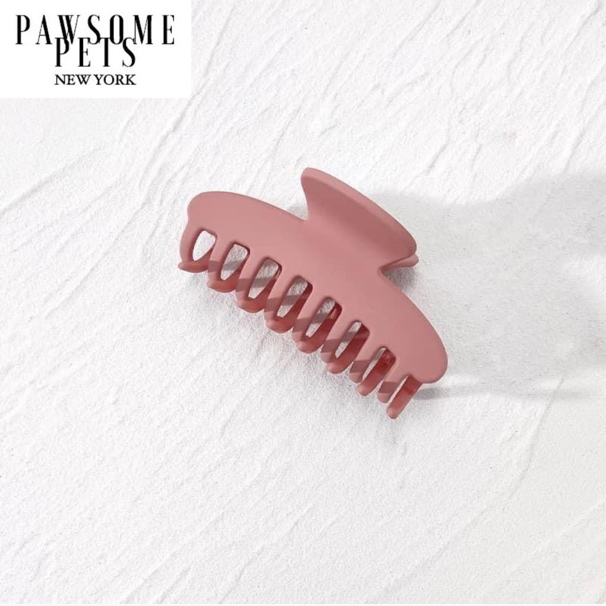 A pair of stylish pink hair claws designed for thick and long hair, showcasing their elegant design and secure grip.
