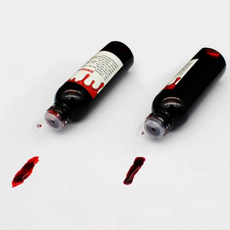 A bottle of ultra-realistic fake blood with a rich red color, perfect for Halloween costumes and special effects makeup.