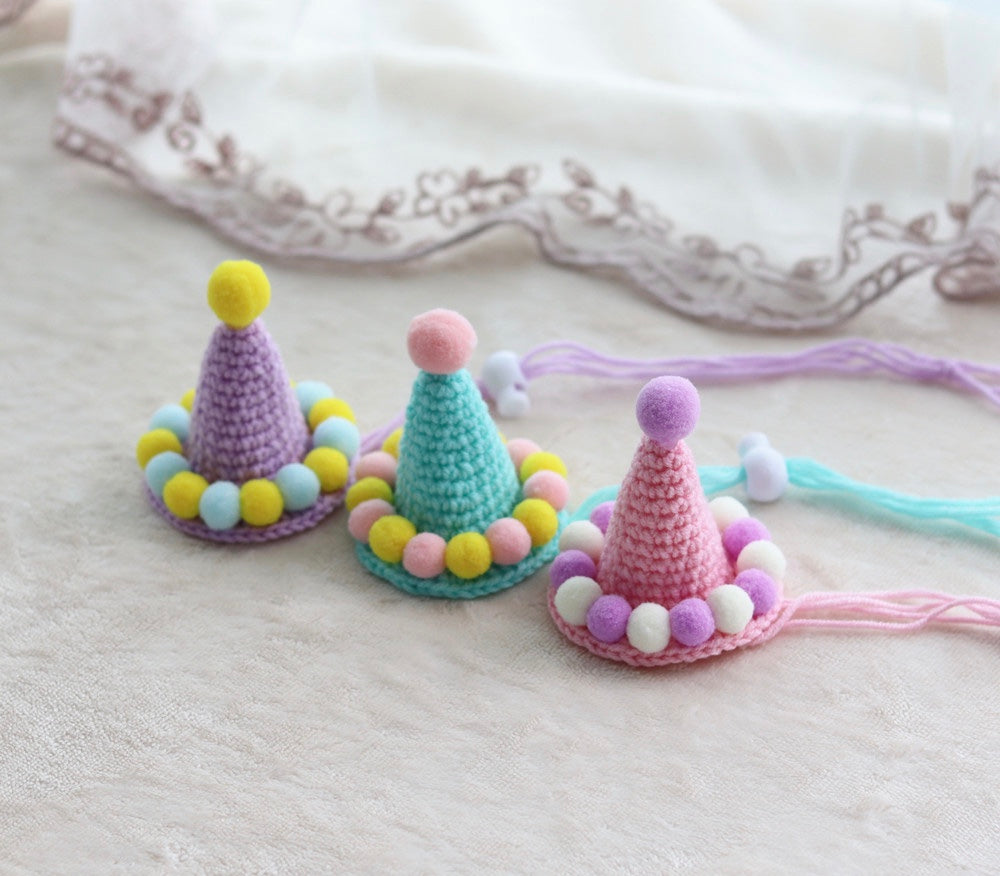 A colorful handmade crochet birthday hat designed for pets, featuring a festive design suitable for dogs, cats, and rabbits.