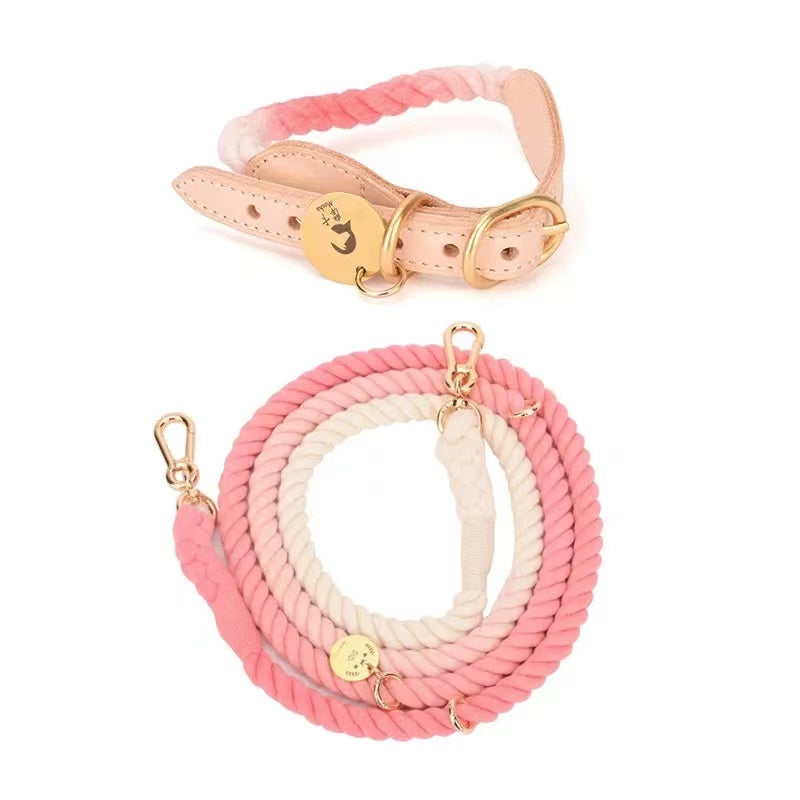 A matching set of a pink leather dog collar and a hand woven cotton rope leash, showcasing solid brass hardware.