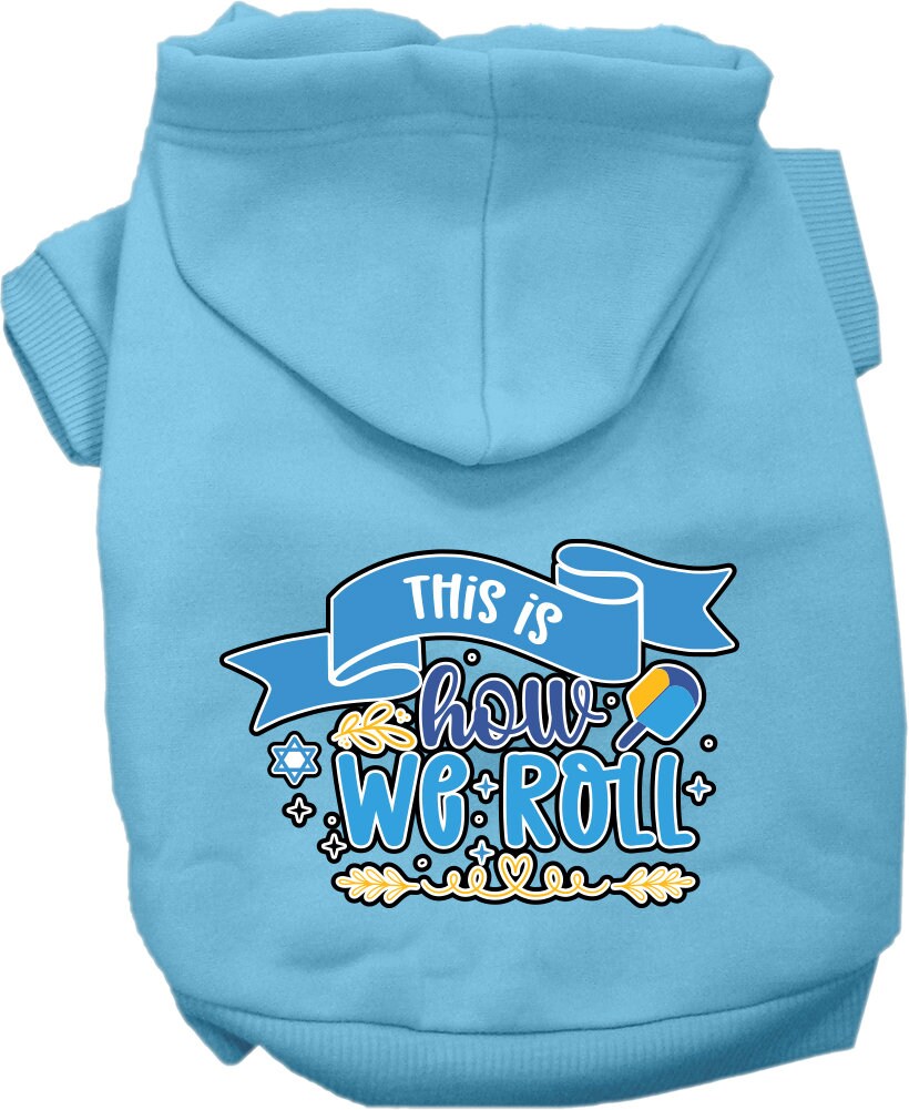 A cozy Hanukkah hoodie for dogs and cats, featuring the phrase 'This Is How We Roll' in festive colors, perfect for holiday celebrations.