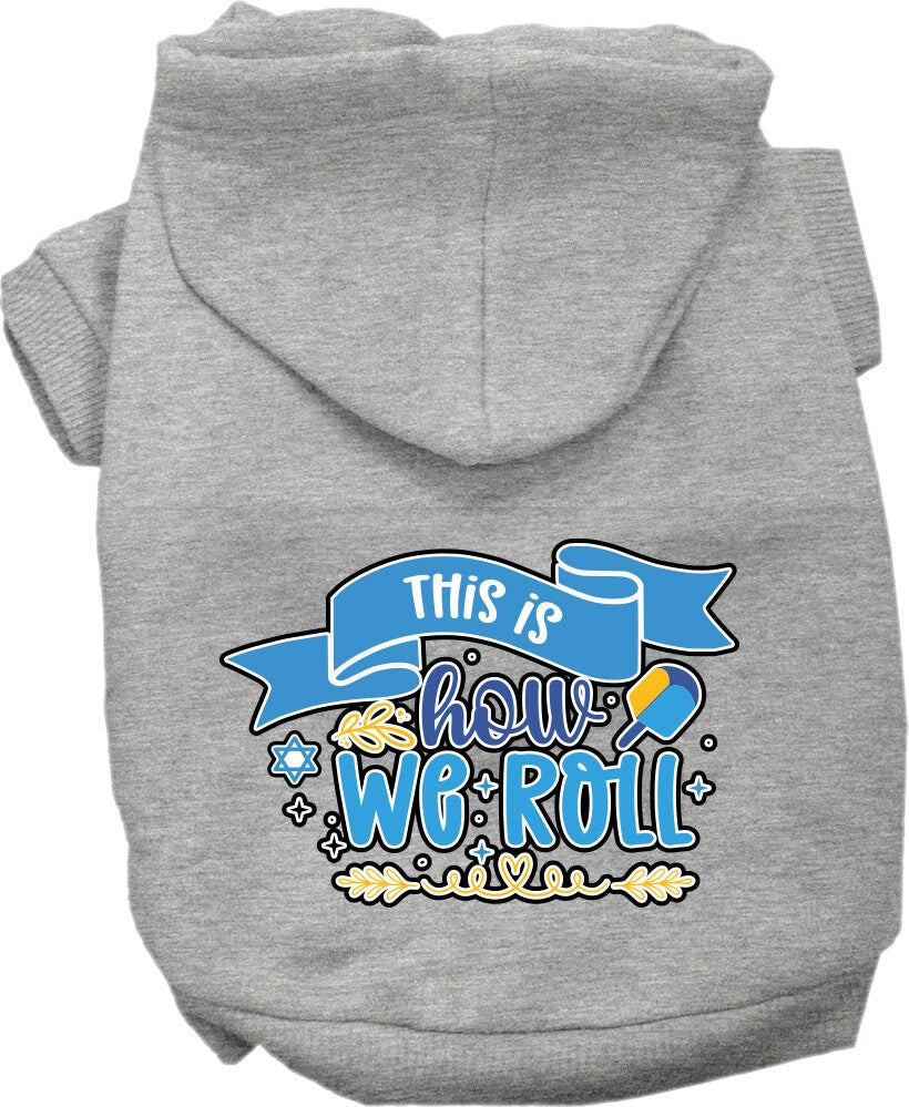 A cozy Hanukkah hoodie for dogs and cats, featuring the phrase 'This Is How We Roll' in festive colors, perfect for holiday celebrations.